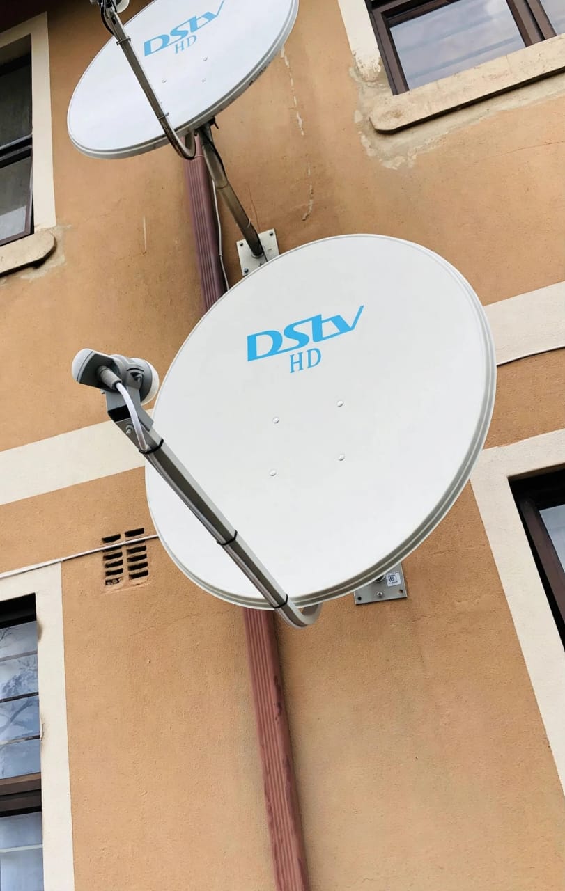 Two DStv HD dishes mounted on a building wall